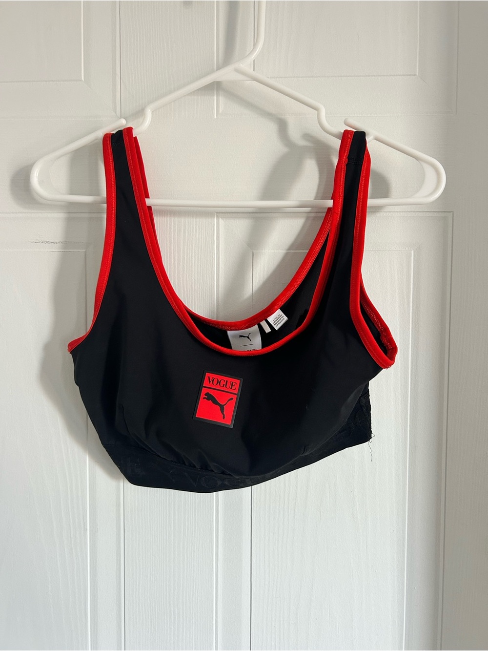 Puma black sports bra with red trim and logo